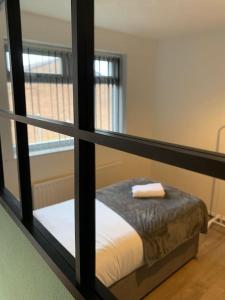 a view of a bedroom with a bed through a window at Contractor Stays by Furnished Accommodation Manchester - Park Your Van on the Driveway with CCTV in Manchester