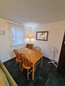 a dining room with a wooden table and chairs at 3 bedroom apartment in Ulverston Cumbria in Ulverston