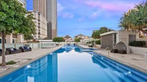 a large swimming pool with blue water in a building at Hilton Five Star Panoramic Oceanview Sub-Penthouse in Gold Coast