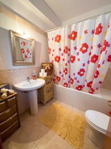 a bathroom with a sink and a shower curtain at The Early Bird - Cosy 2-Floor House with Garden in Alexandroupoli