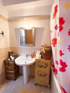 a bathroom with a sink and a mirror at The Early Bird - Cosy 2-Floor House with Garden in Alexandroupoli