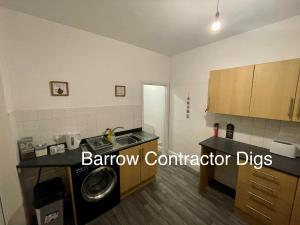 a kitchen with a sink and a washing machine at Barrow Contractor Digs, Serviced Accommodation, Home from Home in Barrow in Furness