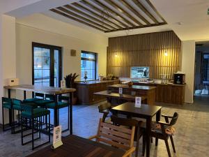 a restaurant with tables and chairs and a kitchen at Hotel Panaya in Gokceada Town