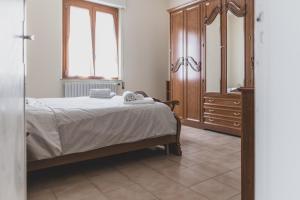 a bedroom with a bed and a dresser at Casa Nanni - Pesaro in Pesaro