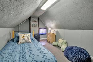 a bedroom with a blue bed in a attic at Welcome to our Cozy Krib in Buffalo