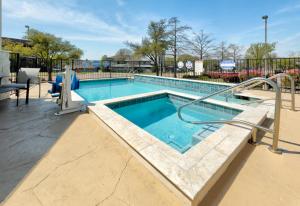 a swimming pool with a slide in the middle at Holiday Inn Express & Suites - Dallas Park Central Northeast, an IHG Hotel in Dallas