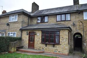 an old brick house with a door and a window at Shaz,s House in Cowley