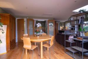 a dining room with a wooden table and chairs at The Nest in Brockenhurst
