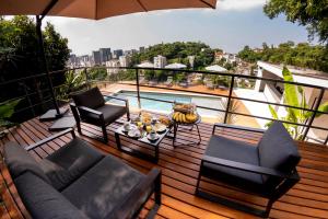 balcón con mesa, sillas y piscina en Hotel Castelinho en Río de Janeiro
