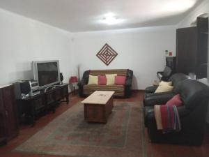 a living room with a couch and a tv at Monte da Samarra in Avis