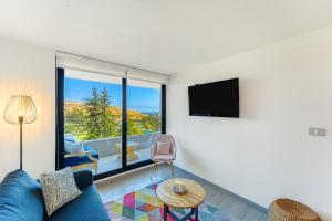 TV a/nebo společenská místnost v ubytování Chic Coast 1D con Vista a Dunas