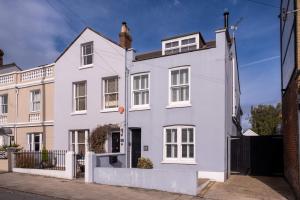 a white house with white windows on a street at Captain's Keep in Lymington