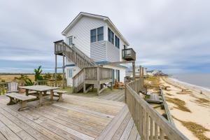 a house on the beach with a picnic table on a wooden deck at Bayfront Cape May Vacation Rental with Beach Access in Cape May Court House