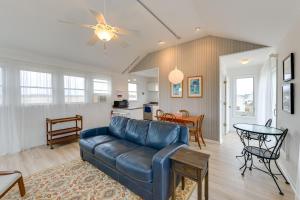 a living room with a blue couch and a table at Bayfront Cape May Vacation Rental with Beach Access in Cape May Court House