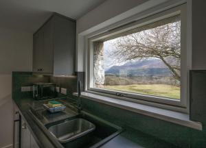 a kitchen with a sink and a large window at The Barn in Fort William
