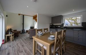 a kitchen and living room with a table and chairs at The Barn in Fort William +16 photos