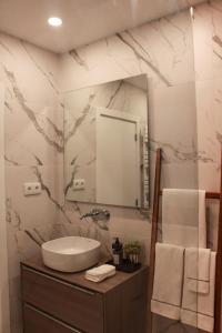 a bathroom with a sink and a mirror at Fornas House in Caminha +19 photos