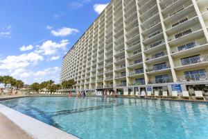 a hotel with a swimming pool in front of a building at The Summit 731 in Panama City Beach