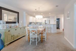 a kitchen and dining room with a table and chairs at Seascape 315 - Oceanfront Condo Overlooking Pool in Isle of Palms