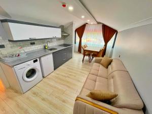 a living room with a couch and a kitchen at EYMEN APARTMENTS in Uzungöl