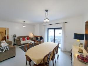 a living room with a table and a couch at Appartement 4 pièces in Ponte de Lima