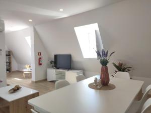 a white living room with a white table and chairs at Aveiro Ria House E in Aveiro