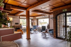 a room with a lobby with chairs and a door at Mike‘s Mosel Lodge in Treis-Karden
