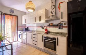 a kitchen with white cabinets and a stove top oven at Gorgeous Home In Isla Plana With Wifi in Isla Plana
