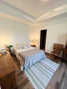 a bedroom with a bed and a wooden floor at Casa 9 de julio in Tandil