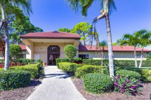 a house with palm trees and a walkway at Yellow Pine Duplex Close to Pool & Tennis in Sarasota