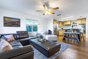 a living room with a couch and a table at Quaint Cottage in a South Sarasota Neighborhood in Sarasota