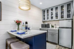 a kitchen with a blue island and a refrigerator at Pelican Gardens 7 By Lido Beach in Sarasota