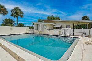 a swimming pool in front of a house at Pelican Gardens Studio 3 on Lido Key in Sarasota