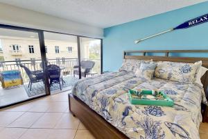 a bedroom with a bed and a balcony at Siesta Sands Beach Resort Gulf View in Sarasota +41 photos