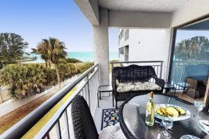 a balcony with a table with bananas on it at Siesta Sands Beach Resort Gulf View in Sarasota