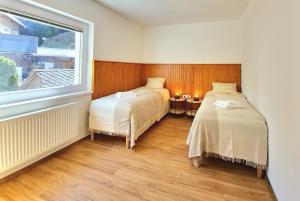 a bedroom with two beds and a window at Bella Bela Apartments 23 in Bled +29 photos