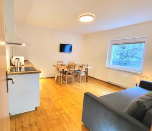 a living room with a kitchen and a table with chairs at Bella Bela Apartments 23 in Bled