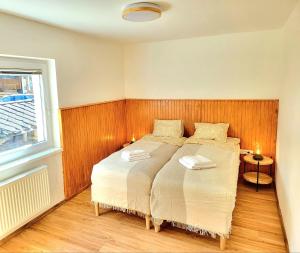 a bedroom with a bed with two pillows on it at Bella Bela Apartments 23 in Bled