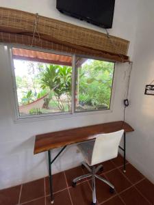 a desk in a room with a window and a chair at A Piece of Paradise in San Carlos