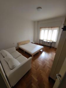 een woonkamer met een bank en een bed bij La casa di Chicco in Trieste