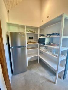 a kitchen with a stainless steel refrigerator at Cabaña con chimenea en Pto Varas in Puerto Varas