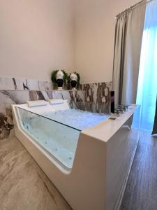 a bathroom with a large tub in a room at Nerina in Catania