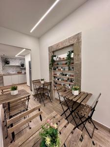 a room with wooden tables and chairs and a book shelf at Nerina in Catania