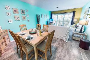 a dining room with a wooden table and chairs at Kingston Arms On Lido Key, 1BR in Sarasota