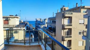 a view of the ocean from a balcony of a building at Spartacus Apartment in Alexandroupoli