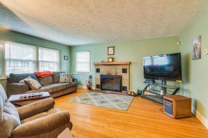 a living room with a couch and a tv and a fireplace at Sodus Point Vacation Rental Steps to Lake Ontario in Sodus