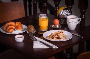 a table with two plates of breakfast food and orange juice at Sure Hotel By Best Western Lorient Centre in Lorient
