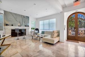 a living room with a couch and a fireplace at Sea Breeze in Miami Beach