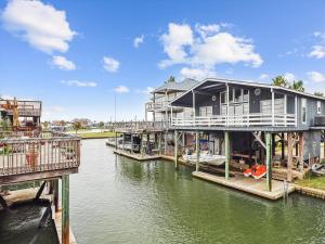 a house on a dock on a body of water at Peggys Hideaway in Galveston