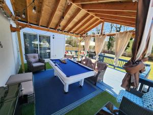 a ping pong table on a covered patio at Paradise Citadel in Mastic